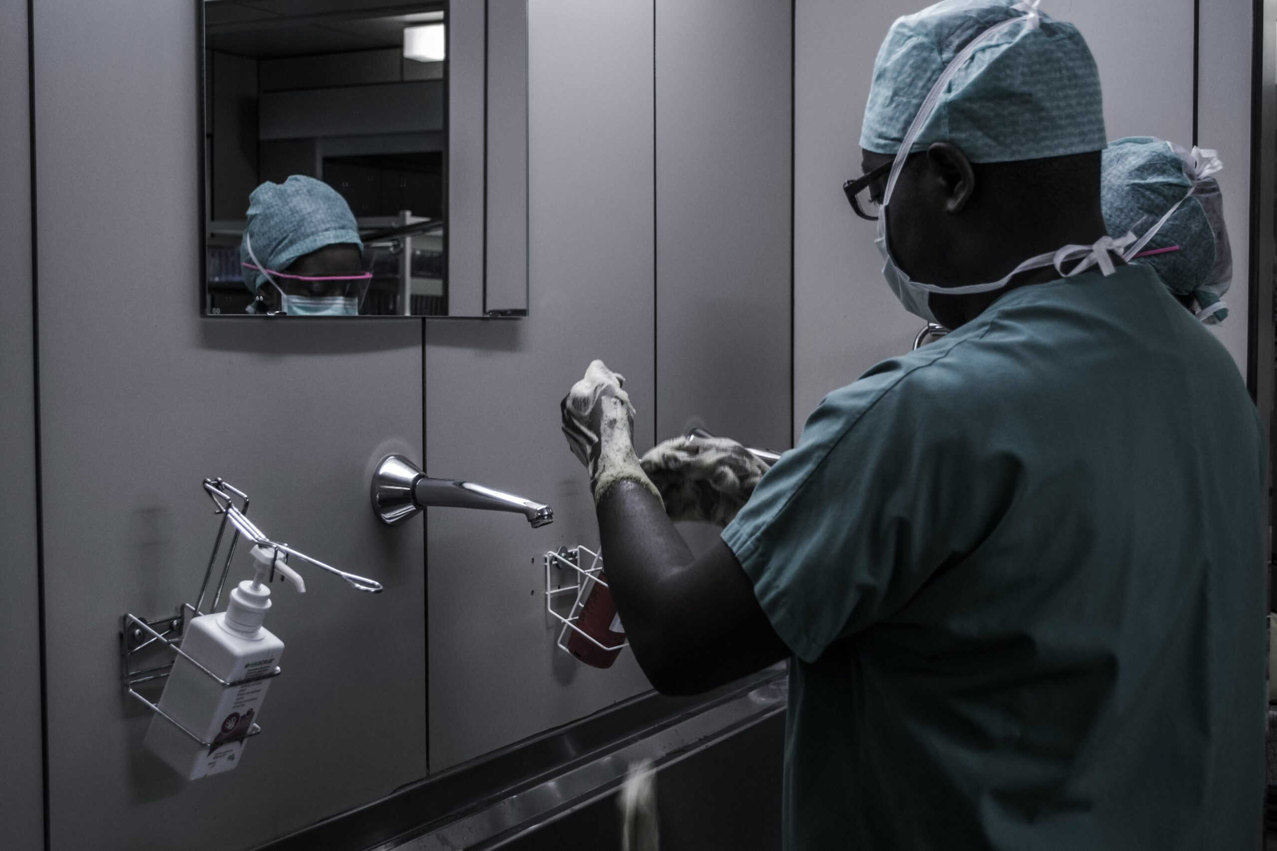 Doctor washing hands thoroughly to prevent infection and promote patient safety.