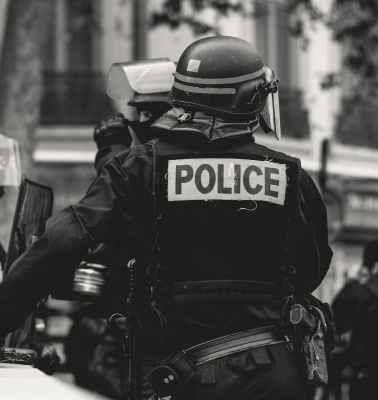 The back of a St. Louis police officer in uniform, relevant to cases handled by a St. Louis civil rights lawyer.